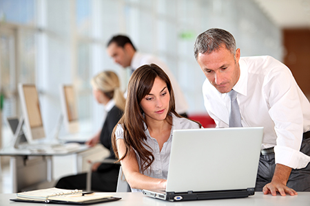 Co-workers looking at computer.