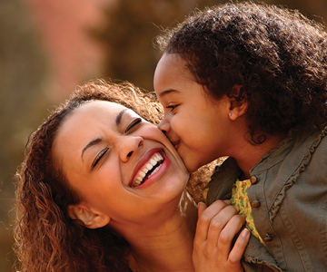 Photo of mother and daughter playing.