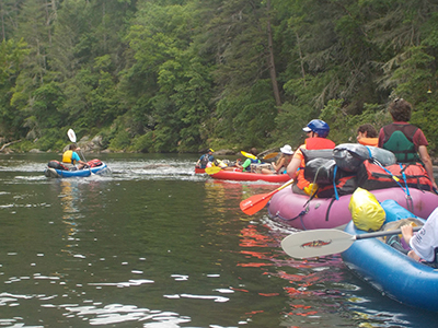 Group of people kayaking down the river.