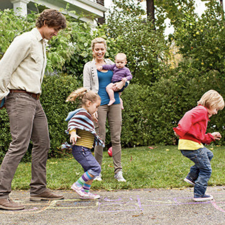 Parents playing with kids outside.