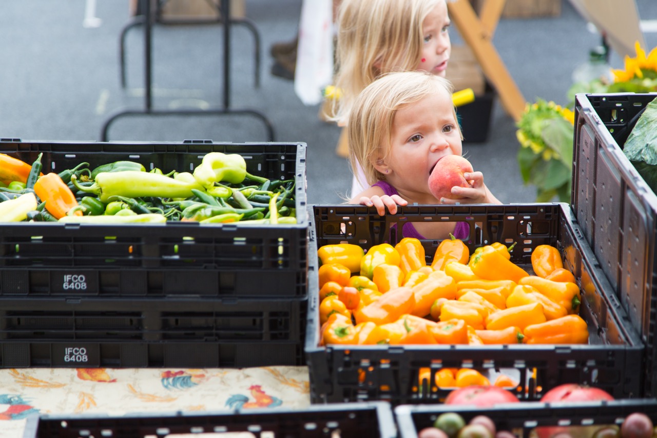 Image of boy eating at the farmers market